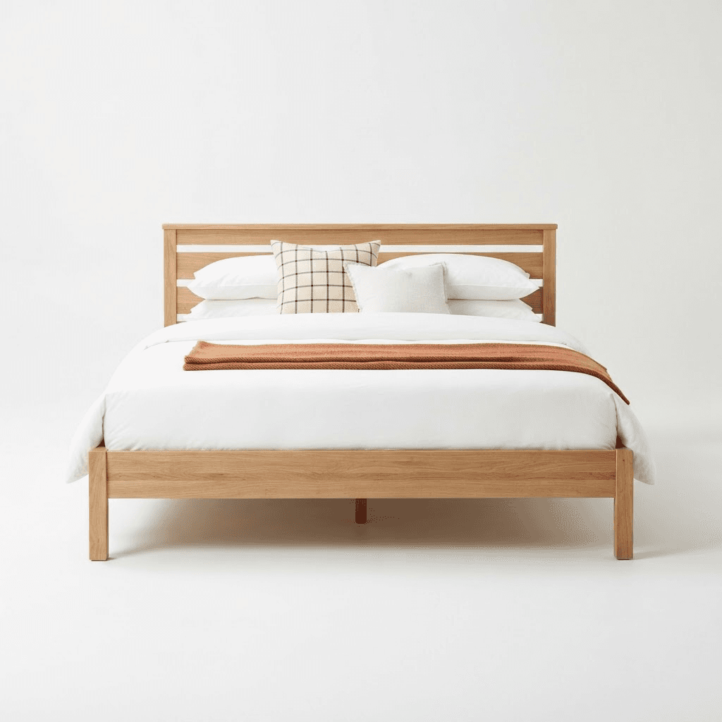 A wooden bed frame with a mattress and pillows